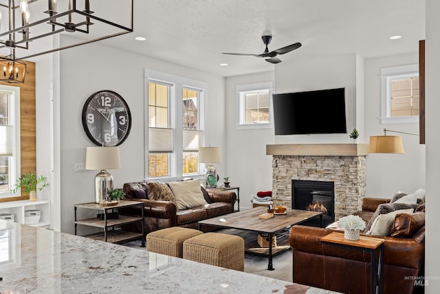 11645 N 24th Ave, Boise, ID 83714 - living area with a stone fireplace, ceiling fan, and recessed lighting
