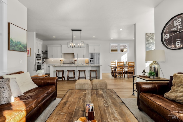 11645 N 24th Ave, Boise, ID 83714 - living room featuring light wood-style flooring and recessed lighting