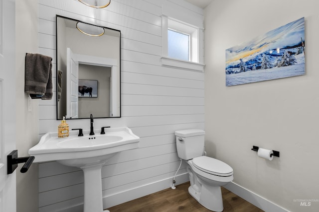 11645 N 24th Ave, Boise, ID 83714 - bathroom with baseboards, toilet, and wood finished floors