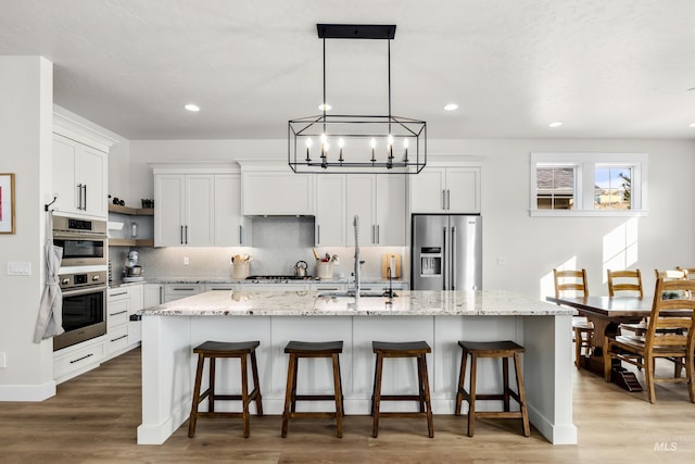 11645 N 24th Ave, Boise, ID 83714 - kitchen featuring decorative backsplash, appliances with stainless steel finishes, a sink, open shelves, and a notable chandelier
