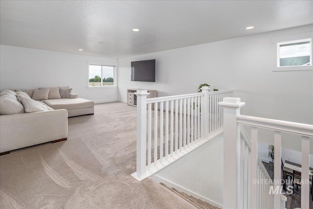 living room featuring recessed lighting, baseboards, and carpet floors