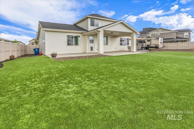 back of house with a lawn, a fenced backyard, and a patio area