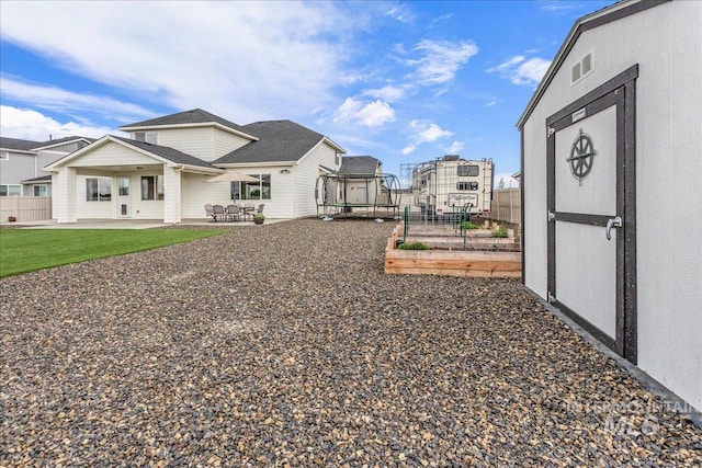 exterior space with a patio area, visible vents, fence, and a garden