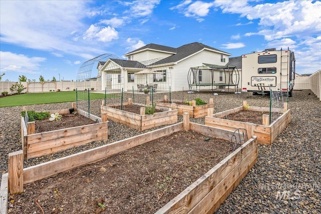 exterior space featuring a vegetable garden and fence