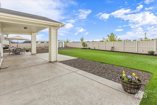 view of patio / terrace featuring a storage unit, a fenced backyard, and an outdoor structure