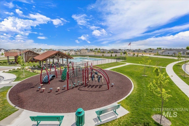 community jungle gym with a yard and a residential view