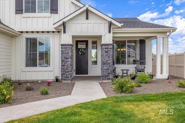 entrance to property with board and batten siding and fence