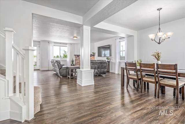 dining room featuring ornate columns, stairway, dark wood-type flooring, and baseboards