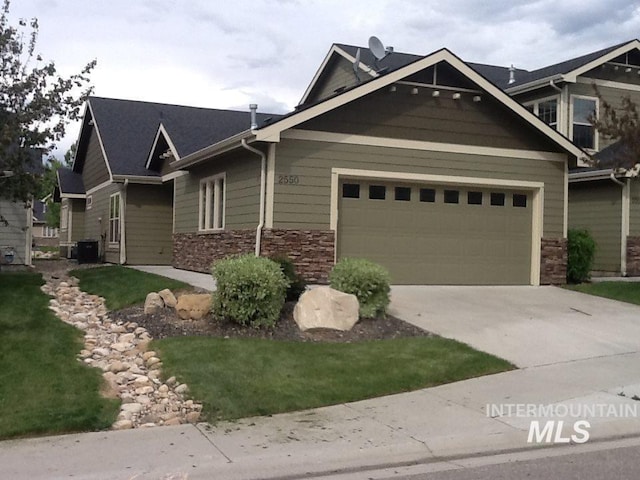 craftsman house featuring central AC and a garage