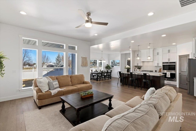 2895 Evening Sun Dr, Twin Falls, ID 83301 - living area with ceiling fan, recessed lighting, light wood finished floors, and baseboards