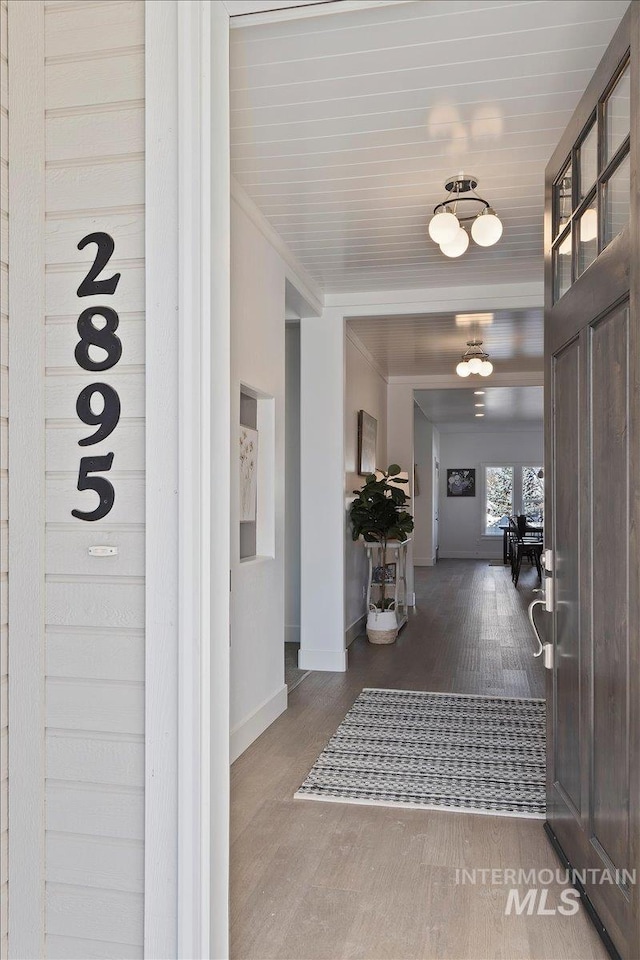 2895 Evening Sun Dr, Twin Falls, ID 83301 - corridor featuring wood finished floors, baseboards, and ornamental molding