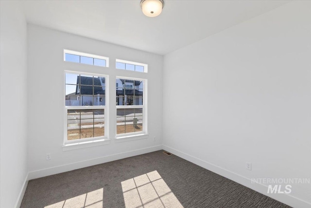 2895 Evening Sun Dr, Twin Falls, ID 83301 - empty room with dark colored carpet and baseboards