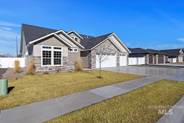 2895 Evening Sun Dr, Twin Falls, ID 83301 - view of front facade featuring stone siding, an attached garage, and driveway