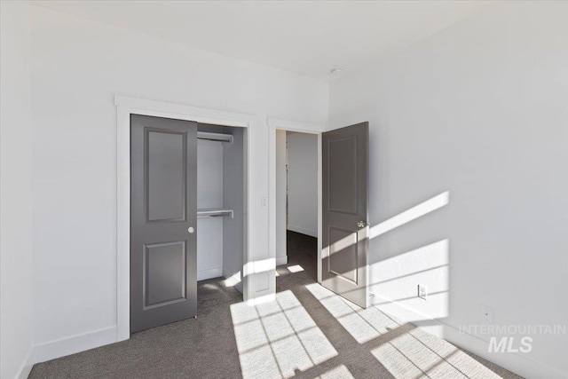 2895 Evening Sun Dr, Twin Falls, ID 83301 - unfurnished bedroom with dark carpet, baseboards, and a closet