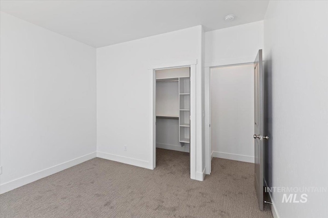 2895 Evening Sun Dr, Twin Falls, ID 83301 - unfurnished bedroom featuring carpet floors, a walk in closet, a closet, and baseboards