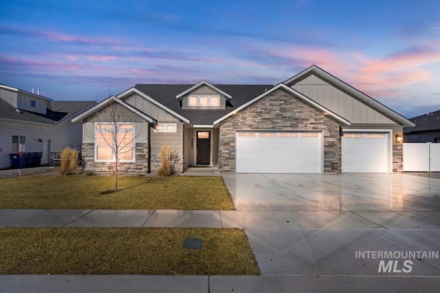 2895 Evening Sun Dr, Twin Falls, ID 83301 - craftsman-style home with board and batten siding, stone siding, driveway, and a lawn