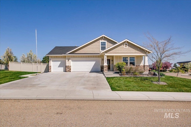 craftsman house featuring concrete driveway, a front lawn, board and batten siding, an attached garage, and fence