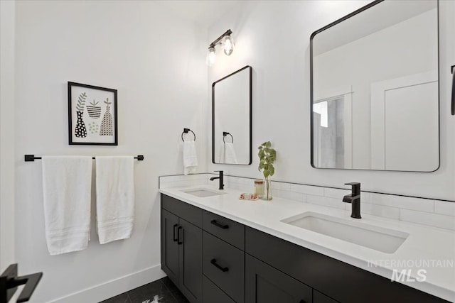 full bathroom with tile patterned floors, baseboards, a sink, and double vanity