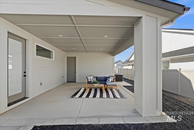 view of patio featuring central AC, outdoor lounge area, and fence