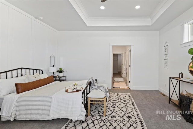 carpeted bedroom featuring recessed lighting, a raised ceiling, baseboards, and ornamental molding