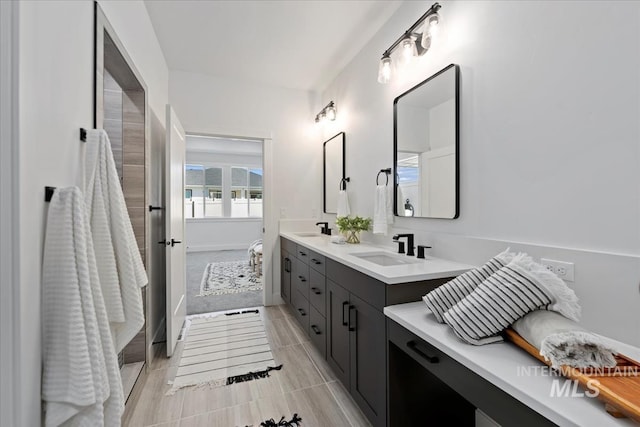 bathroom with double vanity, tile patterned floors, and a sink