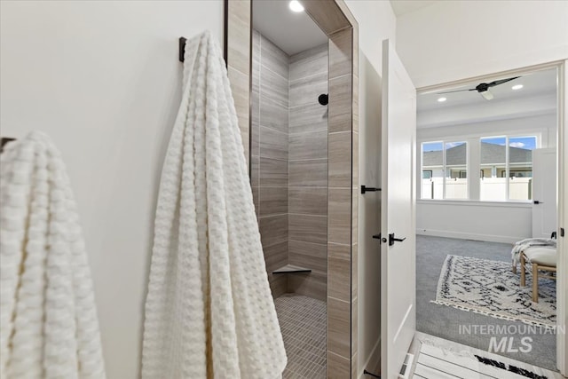 full bathroom featuring recessed lighting, a tile shower, and baseboards