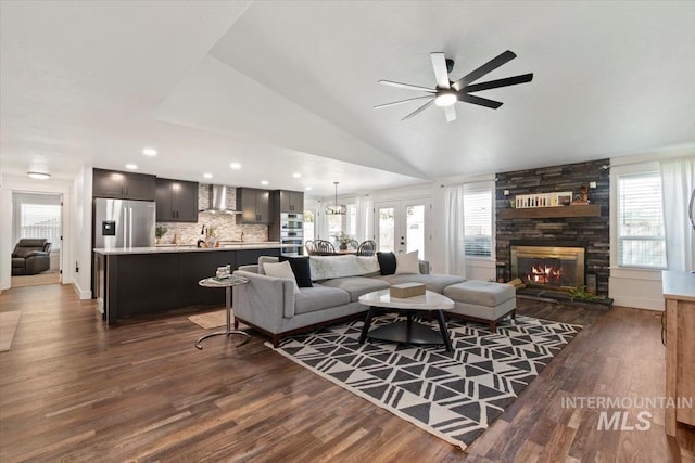 659 N Palmetto Dr, Eagle, ID 83616 - living area with dark wood-type flooring, a stone fireplace, lofted ceiling, and ceiling fan