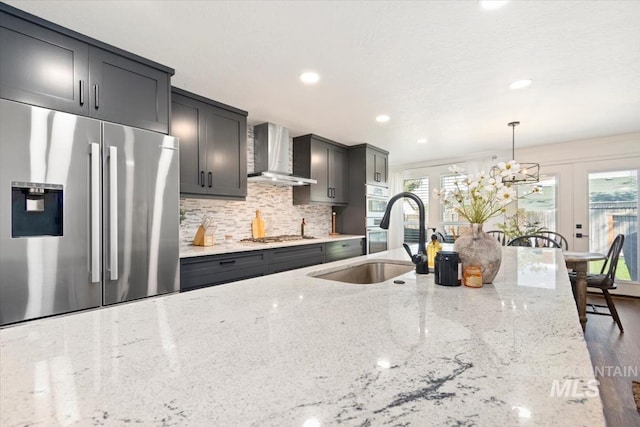 659 N Palmetto Dr, Eagle, ID 83616 - kitchen featuring wall chimney exhaust hood, plenty of natural light, appliances with stainless steel finishes, and hanging light fixtures