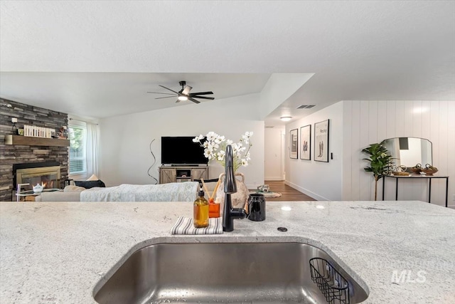 659 N Palmetto Dr, Eagle, ID 83616 - kitchen with open floor plan, visible vents, a sink, and light stone counters