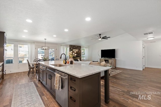 659 N Palmetto Dr, Eagle, ID 83616 - kitchen with dark wood-style floors, baseboards, stainless steel dishwasher, and a sink