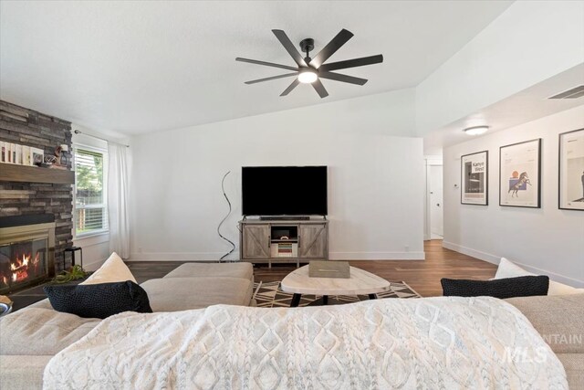 659 N Palmetto Dr, Eagle, ID 83616 - bedroom featuring lofted ceiling, wood finished floors, visible vents, baseboards, and a fireplace