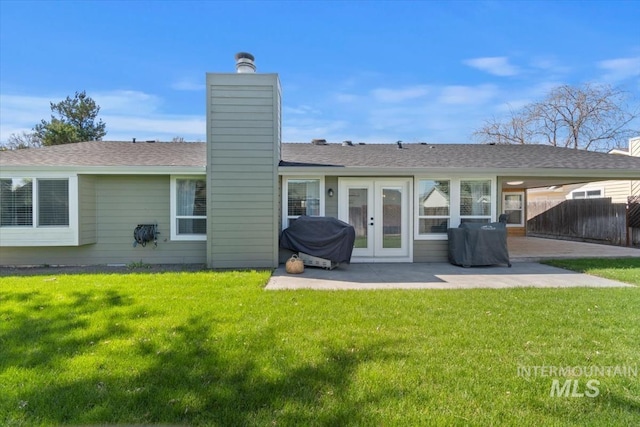 659 N Palmetto Dr, Eagle, ID 83616 - back of house featuring a patio area, a chimney, and a yard