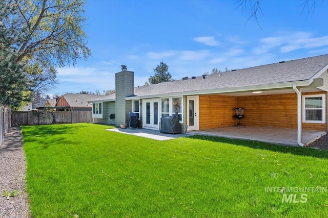 659 N Palmetto Dr, Eagle, ID 83616 - rear view of house with a yard, french doors, a fenced backyard, and a patio