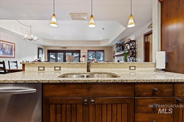 kitchen with dishwasher, sink, a chandelier, and decorative light fixtures