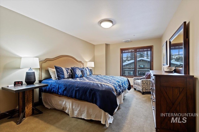 bedroom featuring light carpet