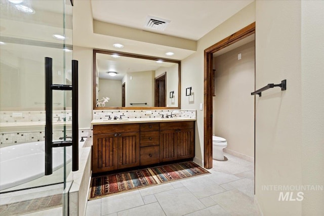 bathroom with vanity, a tub to relax in, toilet, and backsplash