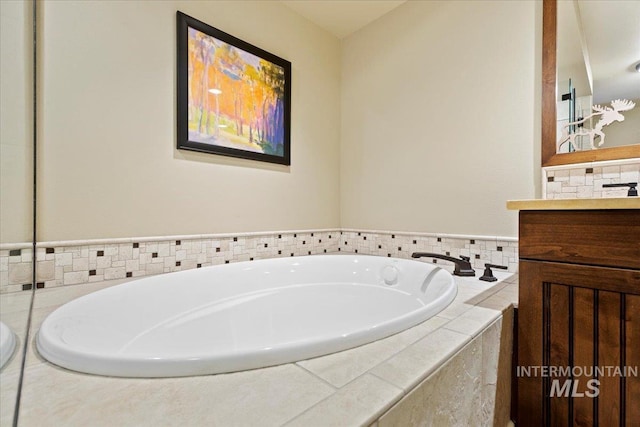 bathroom with vanity and tiled bath