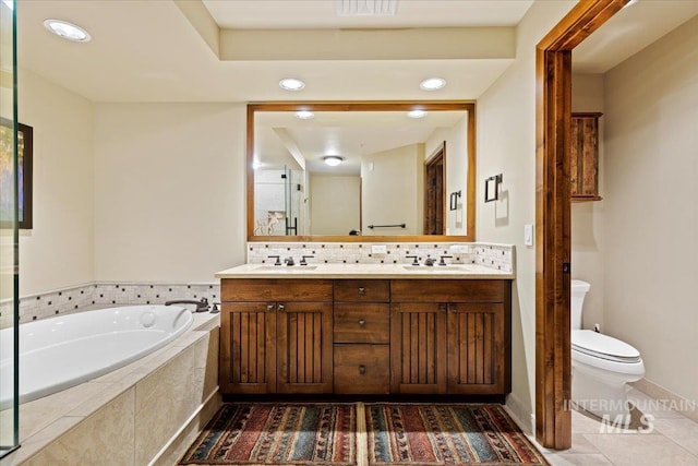 bathroom featuring vanity, tile patterned flooring, a relaxing tiled tub, toilet, and tasteful backsplash