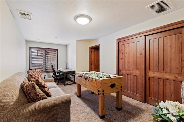 recreation room featuring light colored carpet