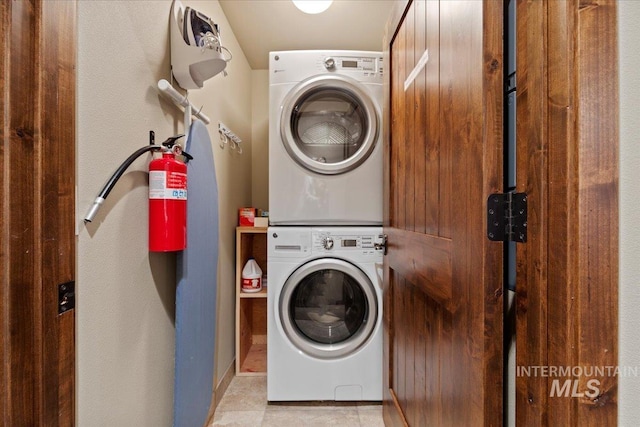 laundry area with stacked washer / drying machine