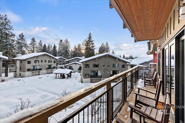 view of snow covered back of property