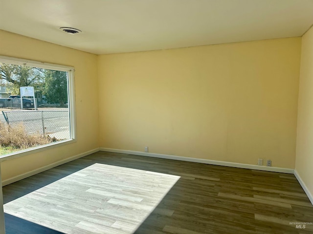 empty room with dark hardwood / wood-style floors