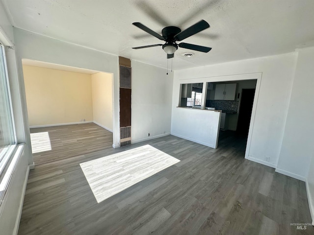 unfurnished living room featuring a textured ceiling, hardwood / wood-style flooring, and ceiling fan