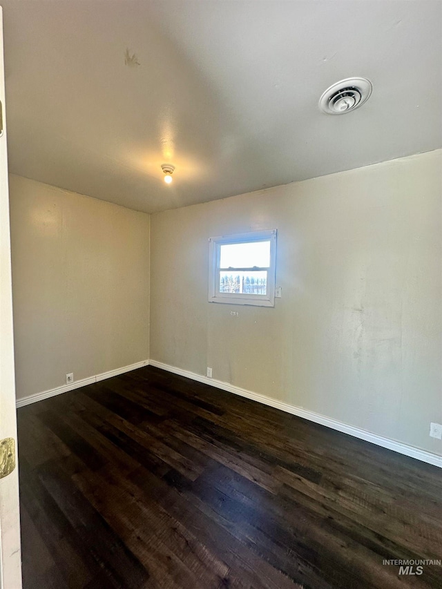 spare room featuring dark hardwood / wood-style flooring