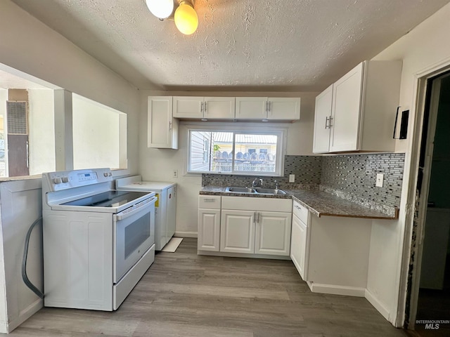 kitchen featuring washer / dryer, white cabinets, white electric range, light hardwood / wood-style flooring, and sink