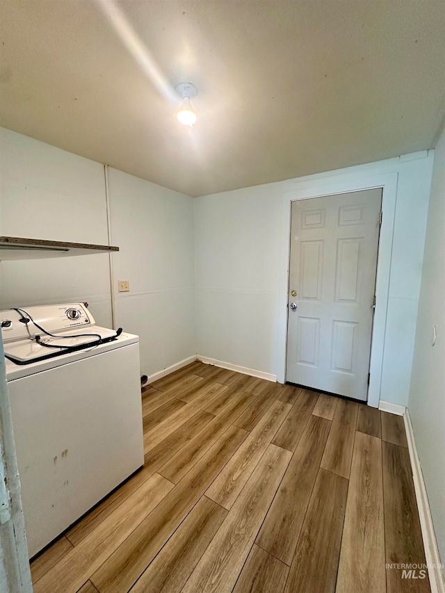 washroom featuring washer / clothes dryer and light wood-type flooring