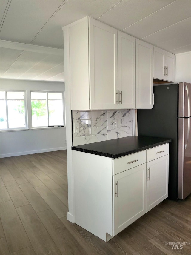 116 E 2nd St, Middleton, ID 83644 - kitchen featuring freestanding refrigerator, dark countertops, white cabinets, and decorative backsplash
