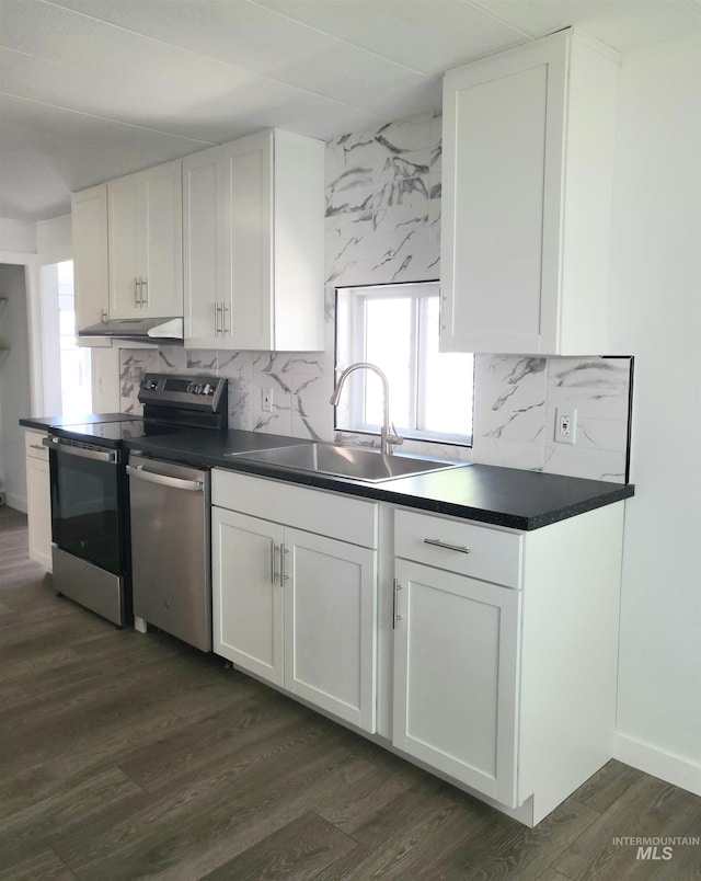 116 E 2nd St, Middleton, ID 83644 - kitchen featuring appliances with stainless steel finishes, a sink, dark countertops, and white cabinetry