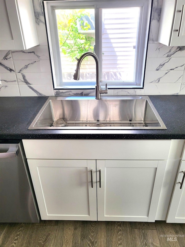 116 E 2nd St, Middleton, ID 83644 - kitchen view of stainless steel dishwasher, a sink, white cabinetry, and decorative backsplash