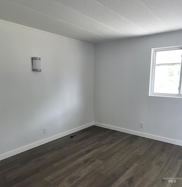 116 E 2nd St, Middleton, ID 83644 - unfurnished room with dark wood-style flooring and baseboards